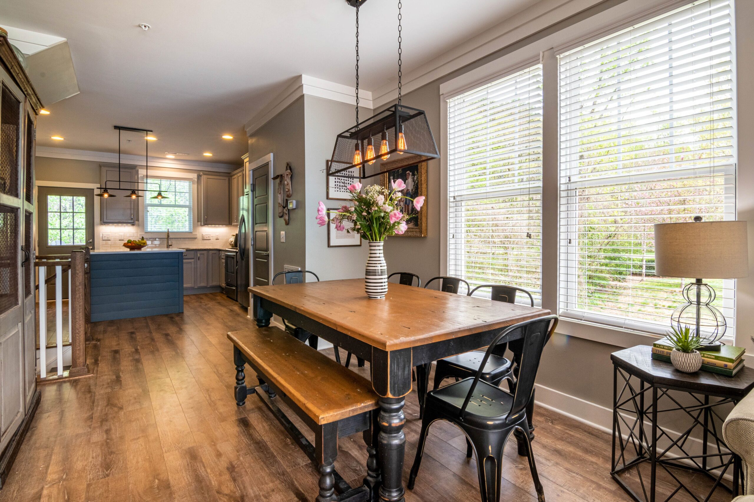 Wooden dining table and chairs beside the windows